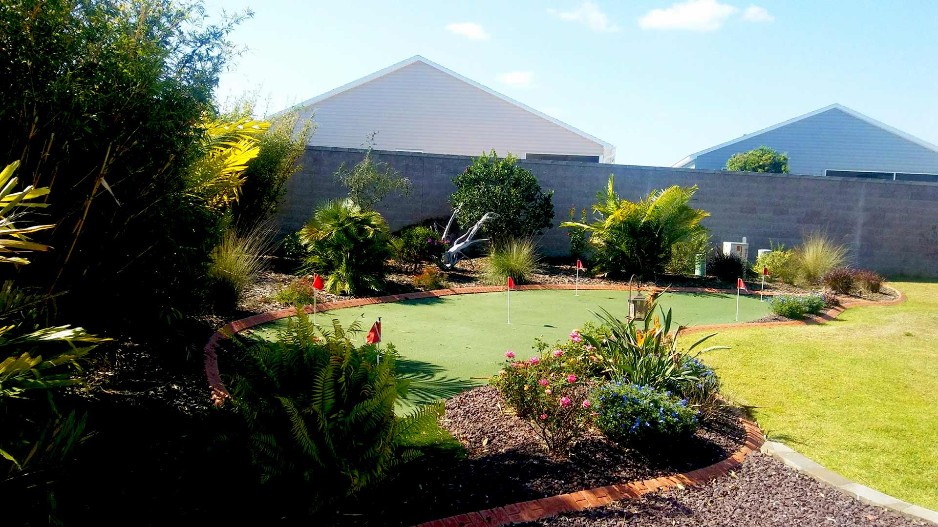 A gorgeous backyard with minigolf and a healthy lawn and shrubs in near Lady Lake, FL.