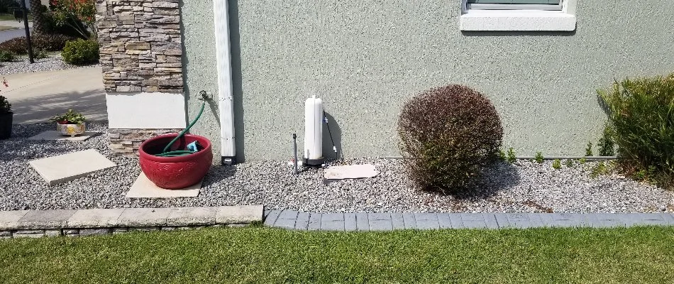 Fertigation unit in rocks along a house in The Villages, FL.