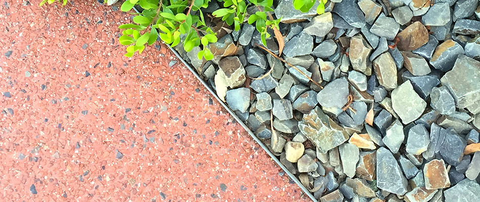 Rocks in a landscape bed, installed by patio to improve a beautiful property in Lady Lake, FL.